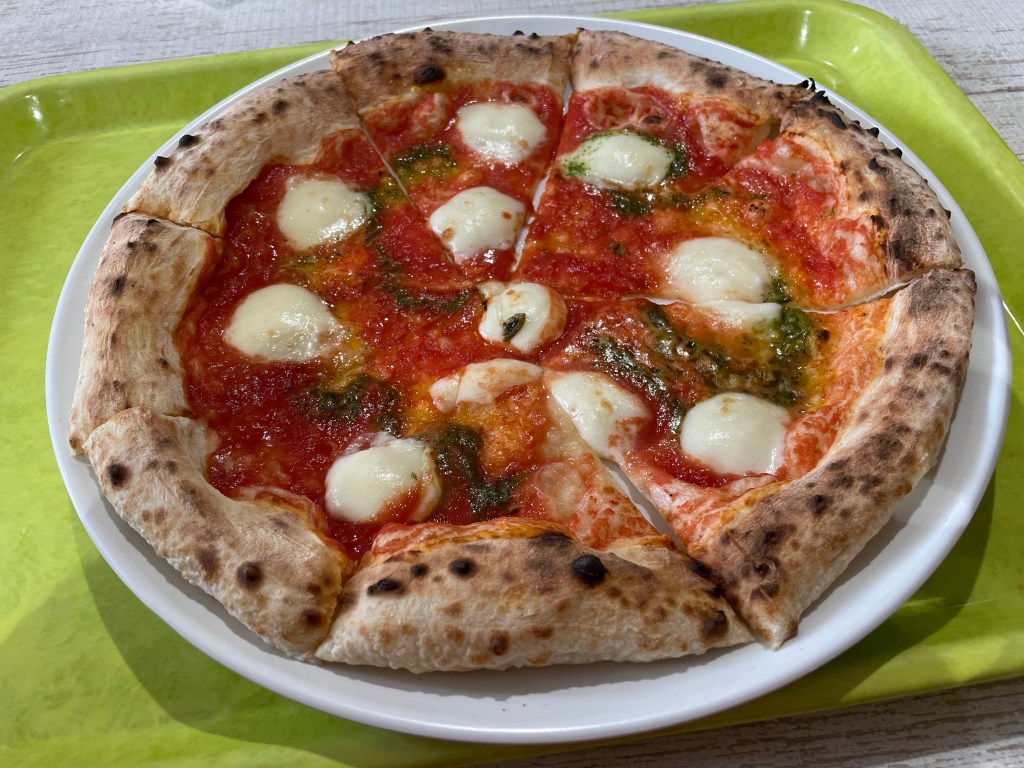 Margherita pizza on a cafeteria tray