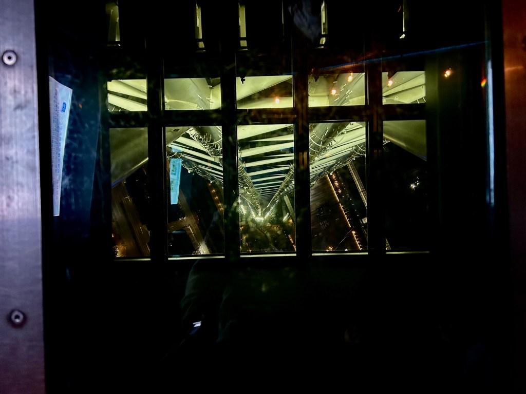 A glass floor with the view looking down the tower