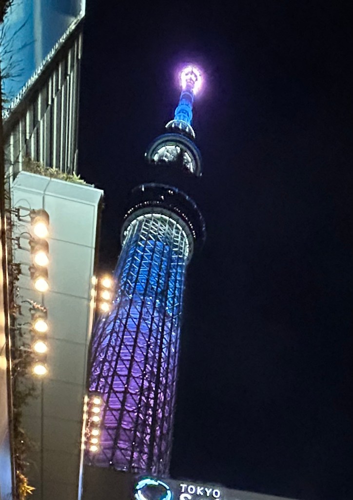 Tokyo Skytree after sunset, lit up with purple and blue lights